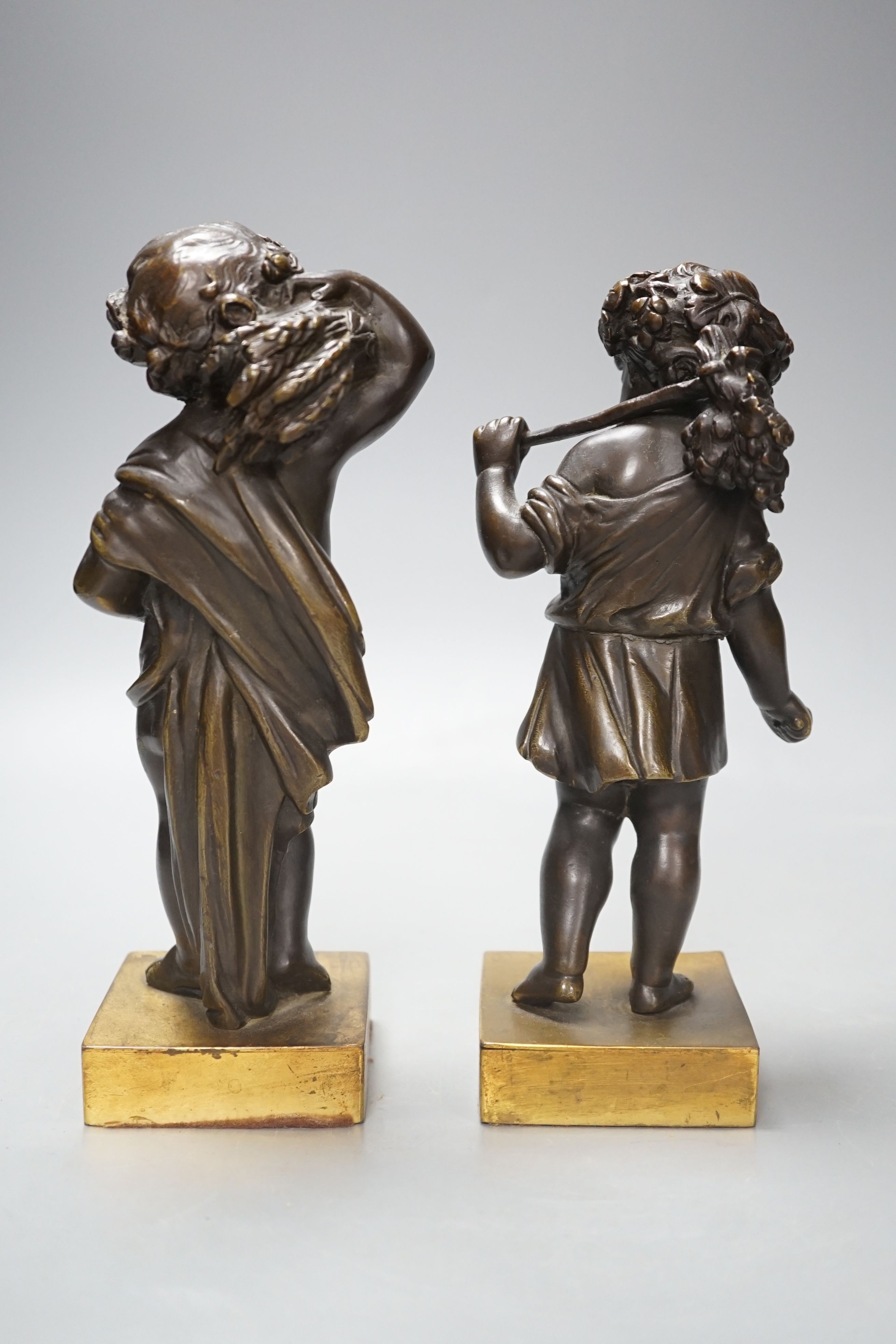 A pair of late 19th century bronze cherubs, emblematic of the seasons, Summer and Autumn, 21cm high